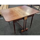 Mahogany Southerland table Standish on brass castors supported by twin turned center supports