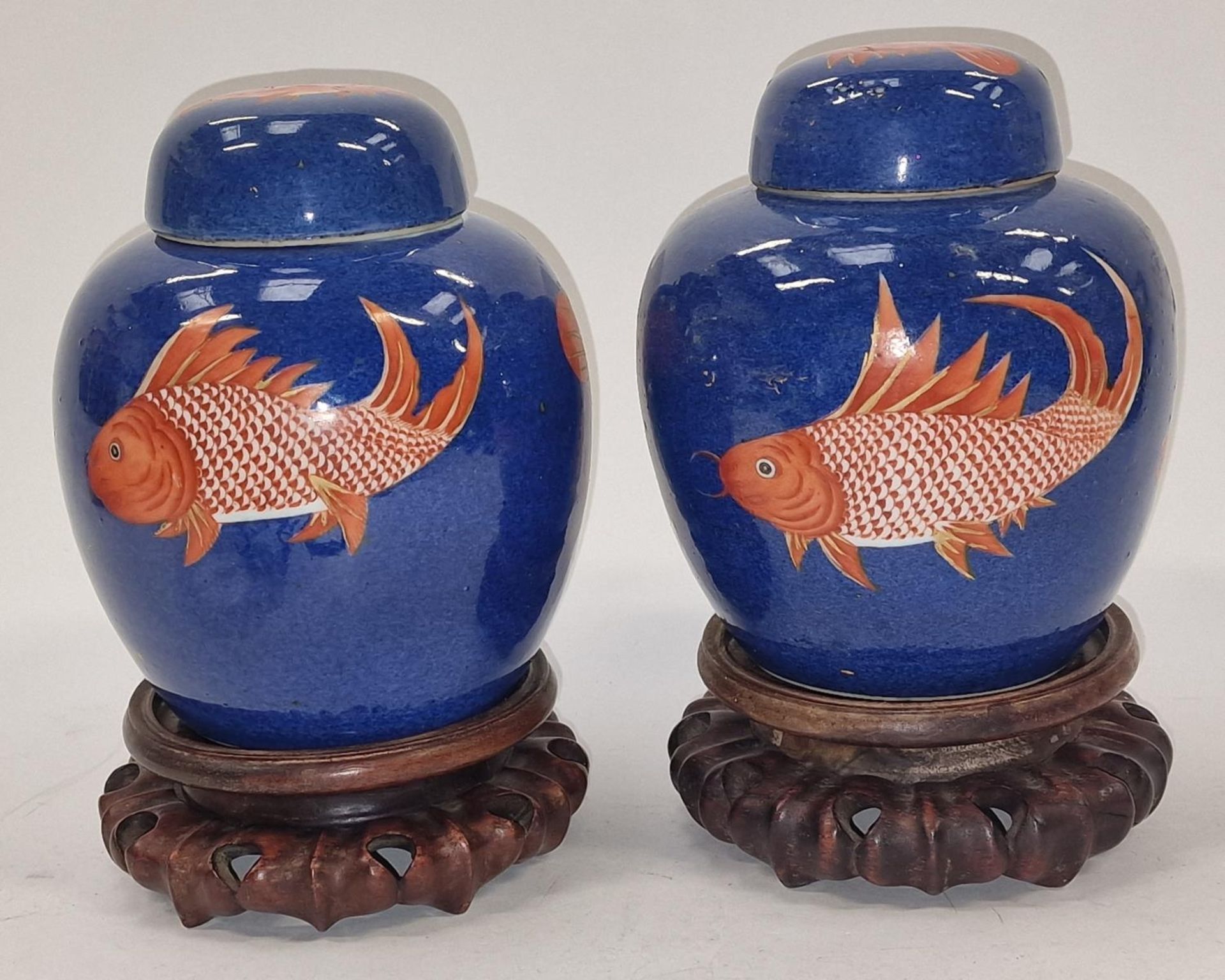 Pair of Oriental Chinese cobalt blue ginger jars decorated with fish on wooden stands each approx