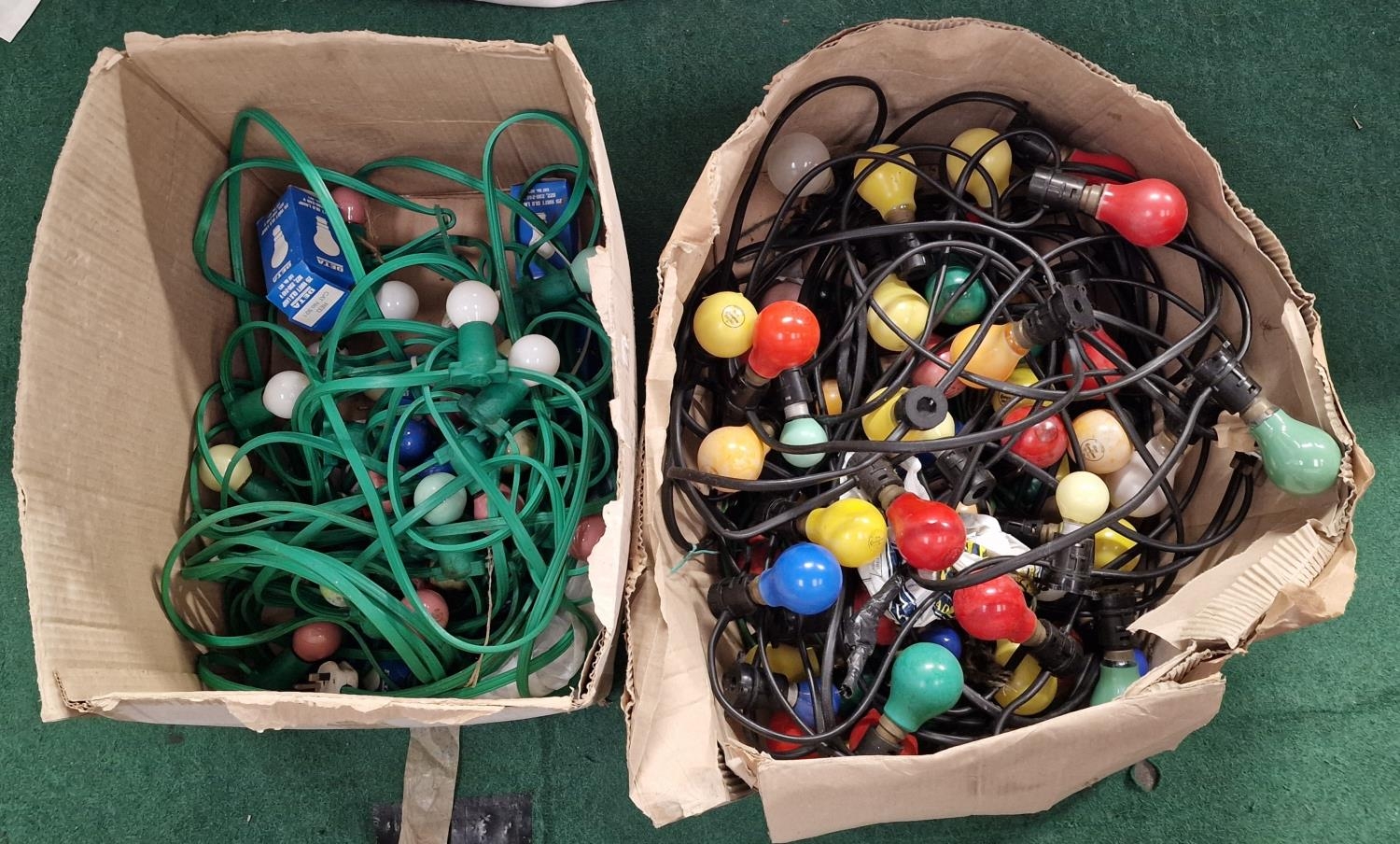 Two boxes of vintage coloured outdoor light bulb strands together with some spare bulbs.