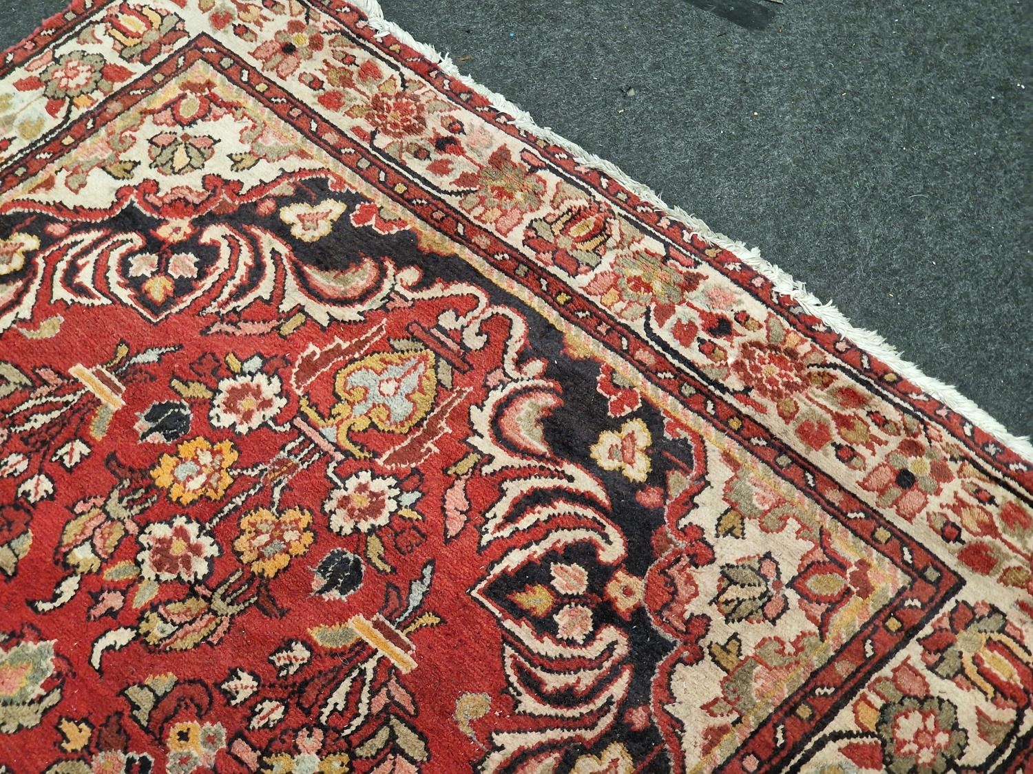 Large vintage patterned carpet on red ground 271x153cm. - Image 4 of 5