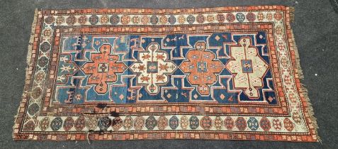 Vintage patterned carpet showing signs of wear 220x110cm.