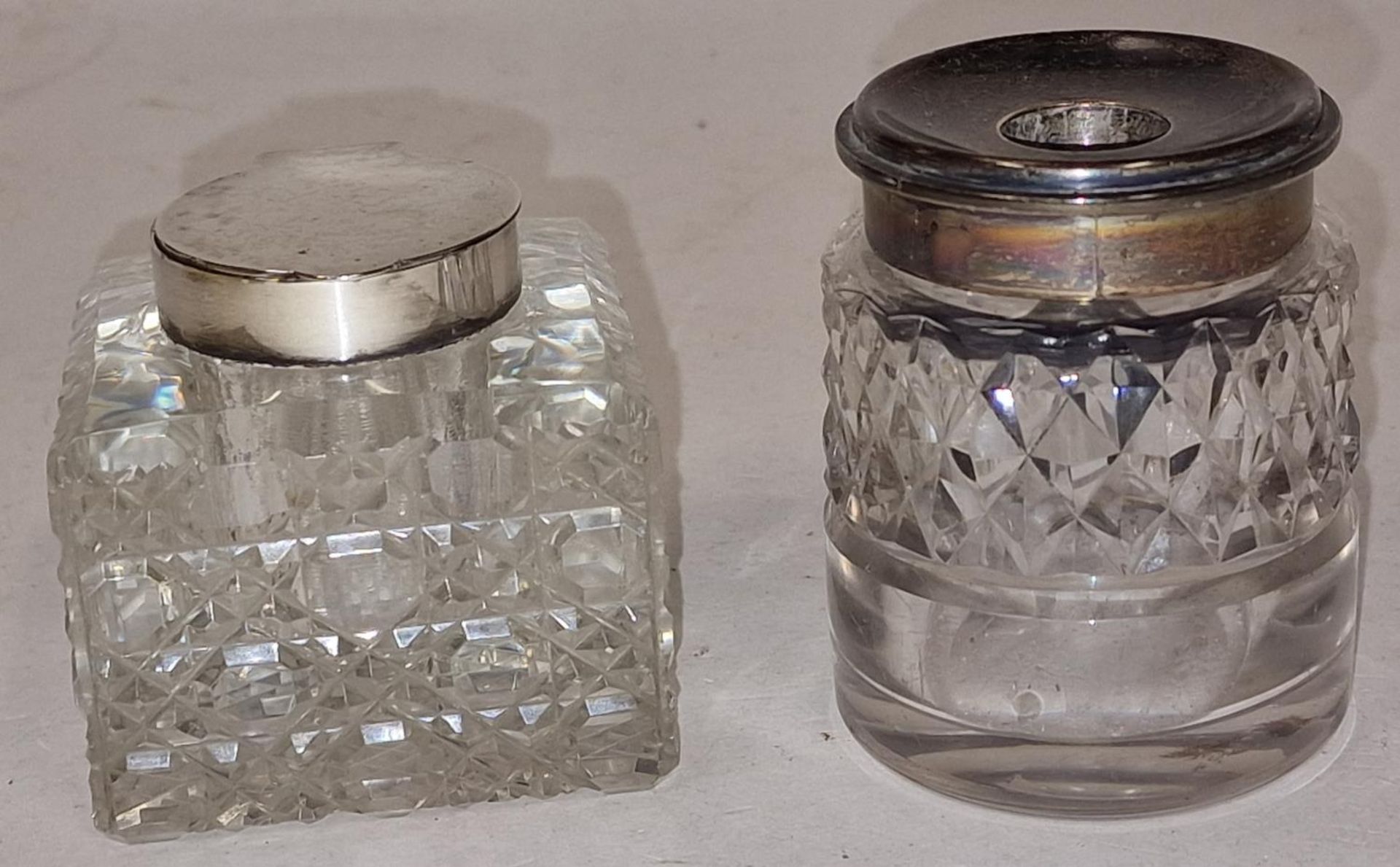 Two Victorian silver topped glass inkwells London 1897 and Chester 1899.
