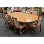 McIntosh vintage 1970's mid 20th century teak extending dining table together with eight chairs to