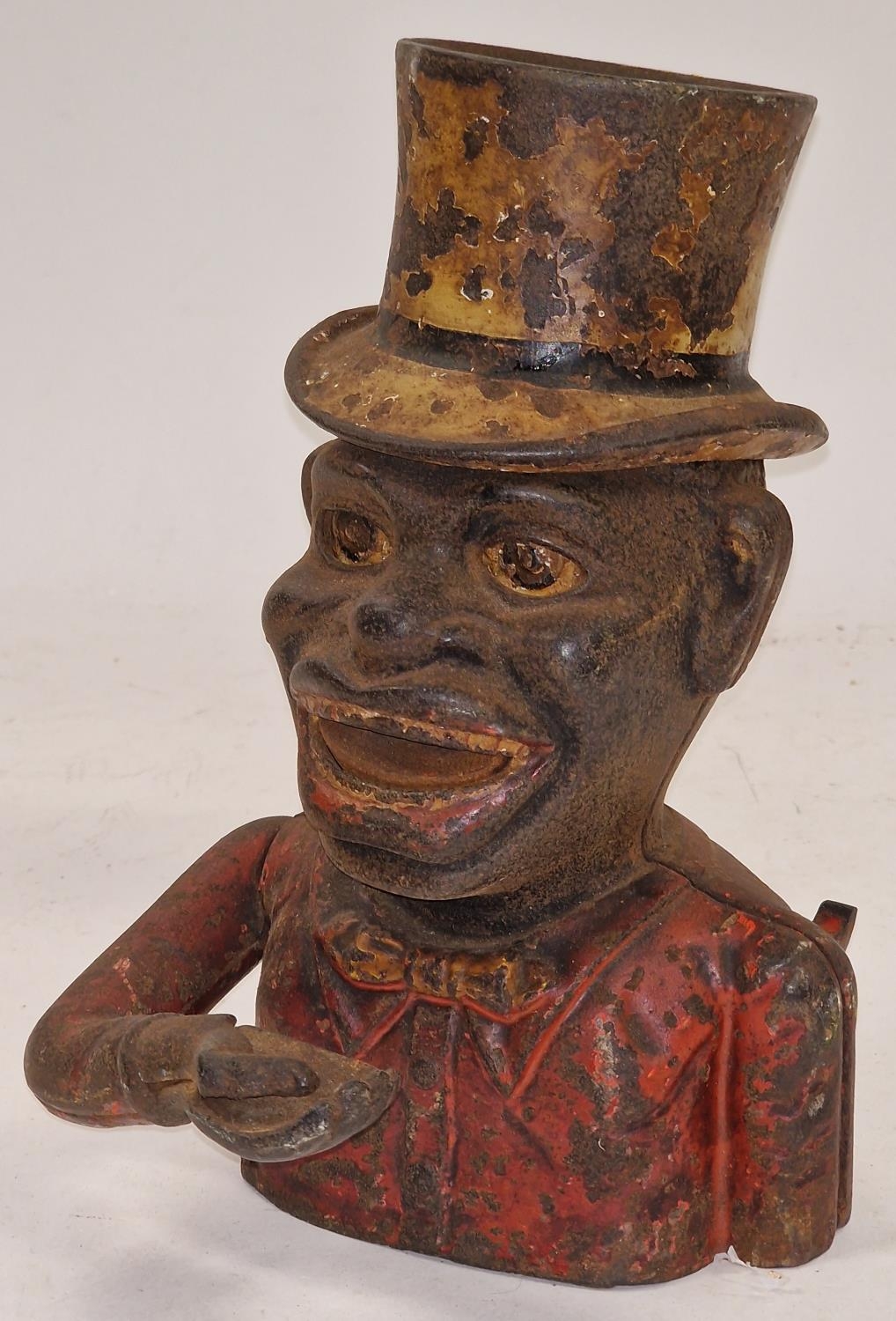 Vintage cast metal money box depicting a fella with a top hat.