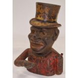 Vintage cast metal money box depicting a fella with a top hat.