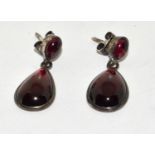 Large natural cabochon pear shaped garnet and silver drop earrings.