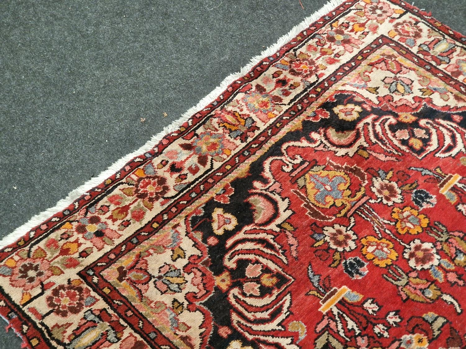 Large vintage patterned carpet on red ground 271x153cm. - Image 3 of 5