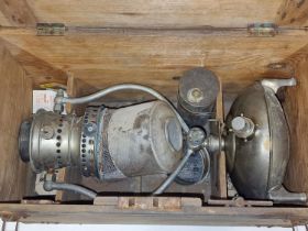 Vintage paraffin storm lamp in fitted wooden case.