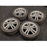 A set of four Volkswagen wheel alloys with tyres attached.