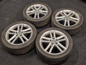 A set of four Volkswagen wheel alloys with tyres attached.