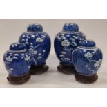 Two pairs of blue and white Chinese ginger jars on wooden stands (one lid af).