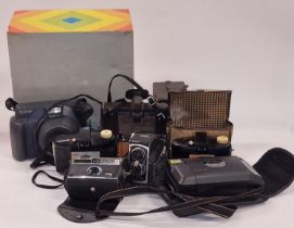 Collection of instant and brownie cameras to include Polaroid and Kodak.