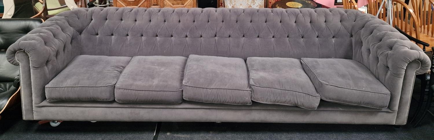 A superb 6+ seater button back chesterfield sofa covered in a grey velour material 90x350x100cm