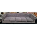 A superb 6+ seater button back chesterfield sofa covered in a grey velour material 90x350x100cm