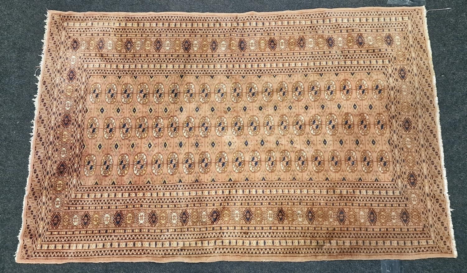 Vintage patterned carpet on brown ground 195x124cm.