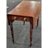 Mahogany Pembroke table supported by turned supports above brass castors having a single draw to one
