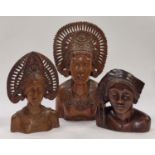 Collection of Indonesian wooden carved busts of varying sizes.