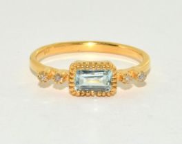 A natural aquamarine and diamond gold on silver ring Size N 1/2.