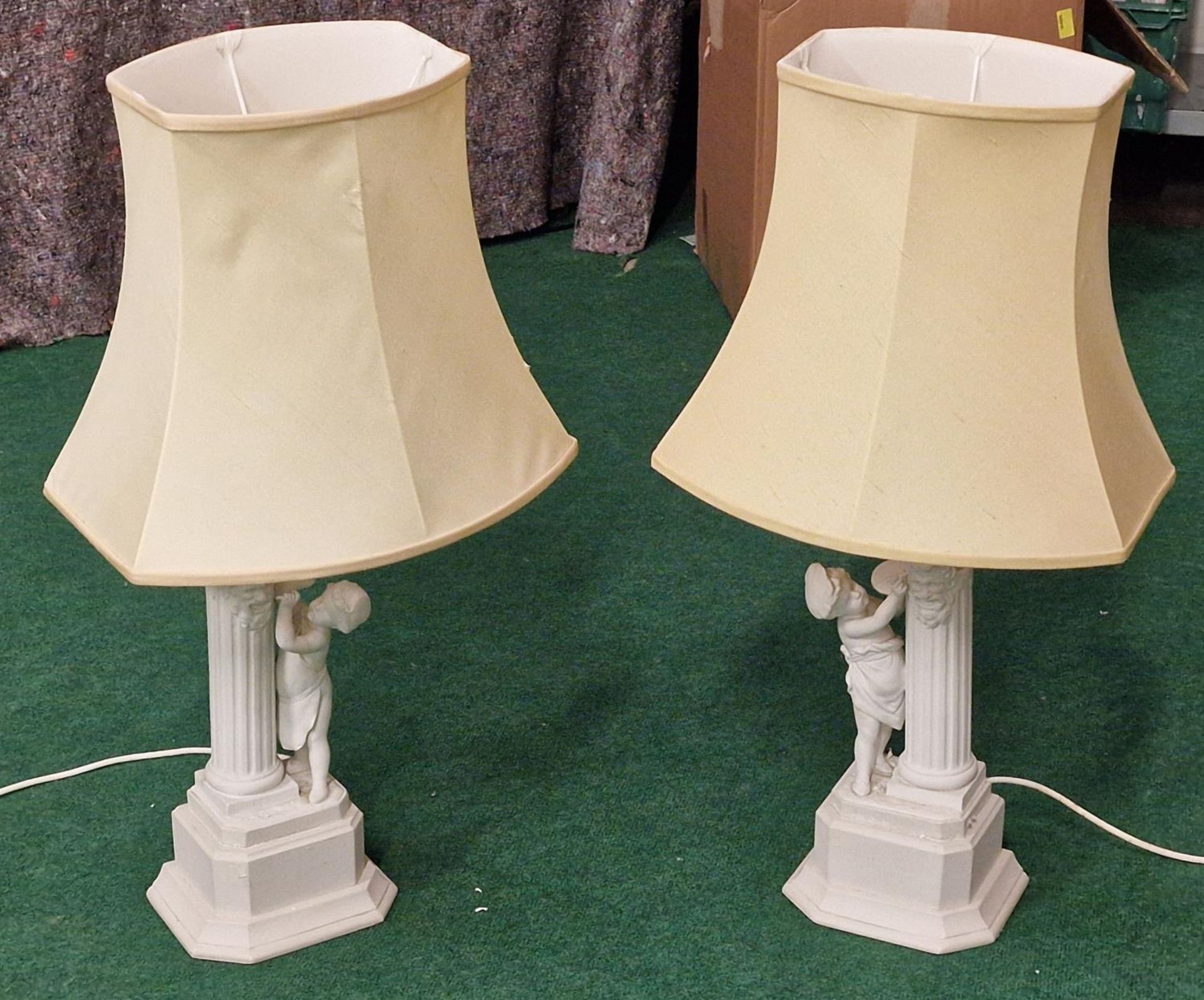 Pair of contemporary table lamps depicting children and Corinthian columns includes shades.