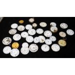 A collection of pocket watch movements, many in working order
