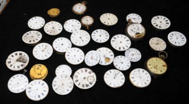 A collection of pocket watch movements, many in working order
