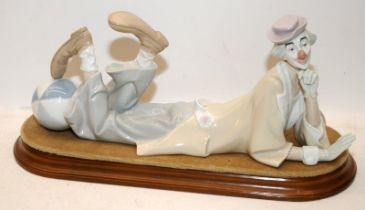 Large Lladro figure of a laying down clown on wooden base 14.75" length.