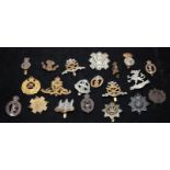 A collection of mostly WWI - WWII Era regimental cap badges, good collectable examples. 20 in lot