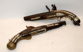 Two antique Indian muskets with MOP inlay, one with a flintlock firing mechanism and one