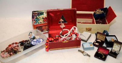 A collection of costume jewellery contained within jewellery boxes and tubs