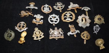 A collection of mostly WWI - WWII Era regimental cap badges, good collectable examples. 20 in lot