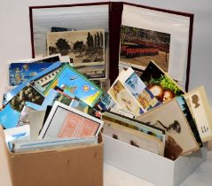 Two boxes and an album of vintage postcards, various ages and images