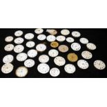 A collection of pocket watch movements, many in working order