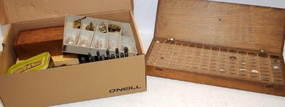 A wooden box containing a collection of sorted watch lenses c/w a box of useful watch makers tools