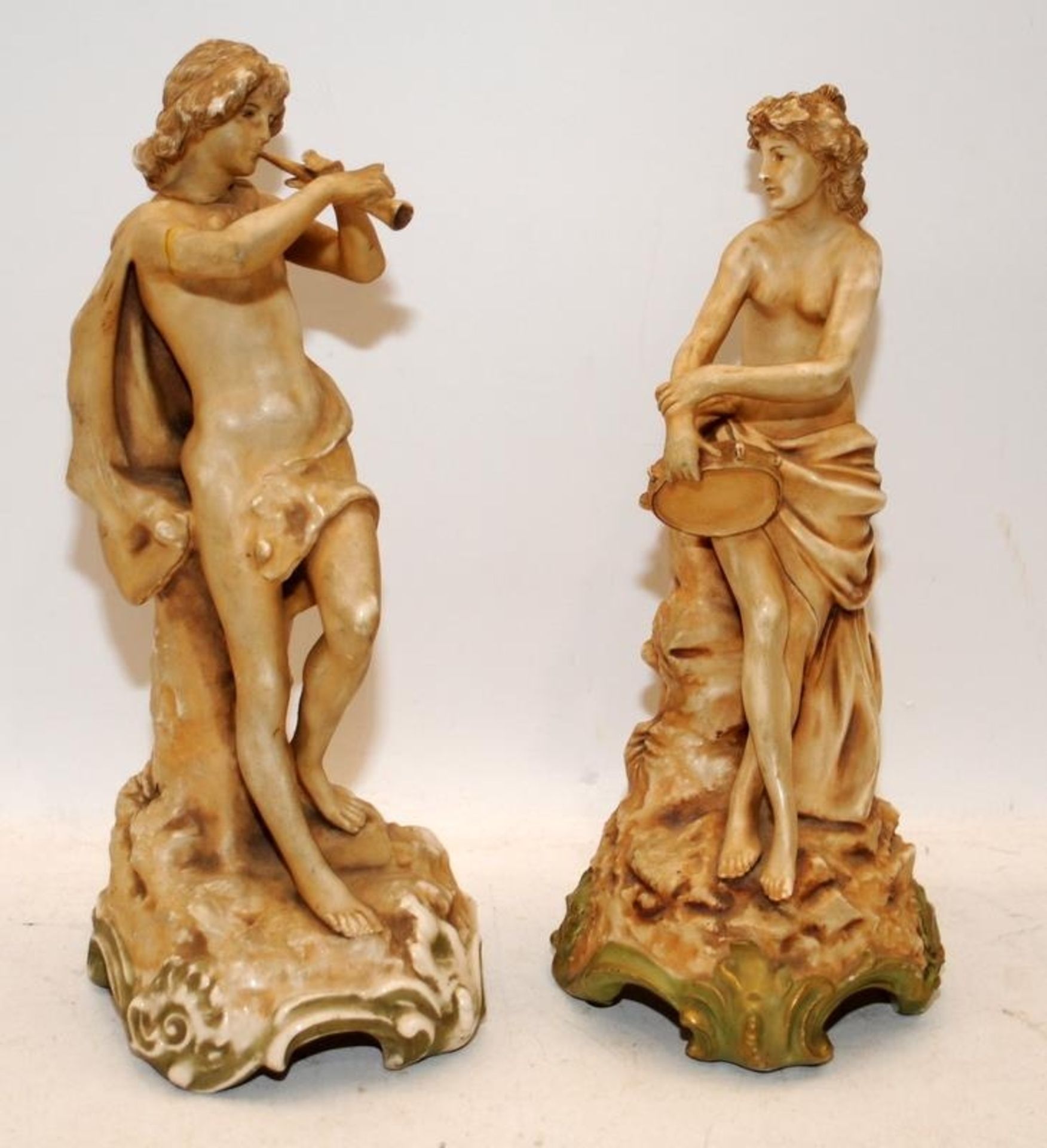 Pair of antique porcelain figures, male playing a pipe and female playing a tambourine. Male