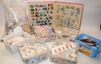 Large collection of loose world stamps to sort, mostly contained within a number of plastic tubs