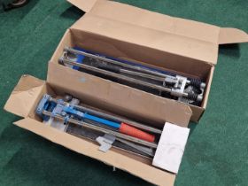 Two boxed tile cutters.