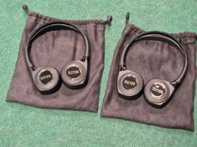 Two pairs of genuine Range Rover headphones with fabric cases.