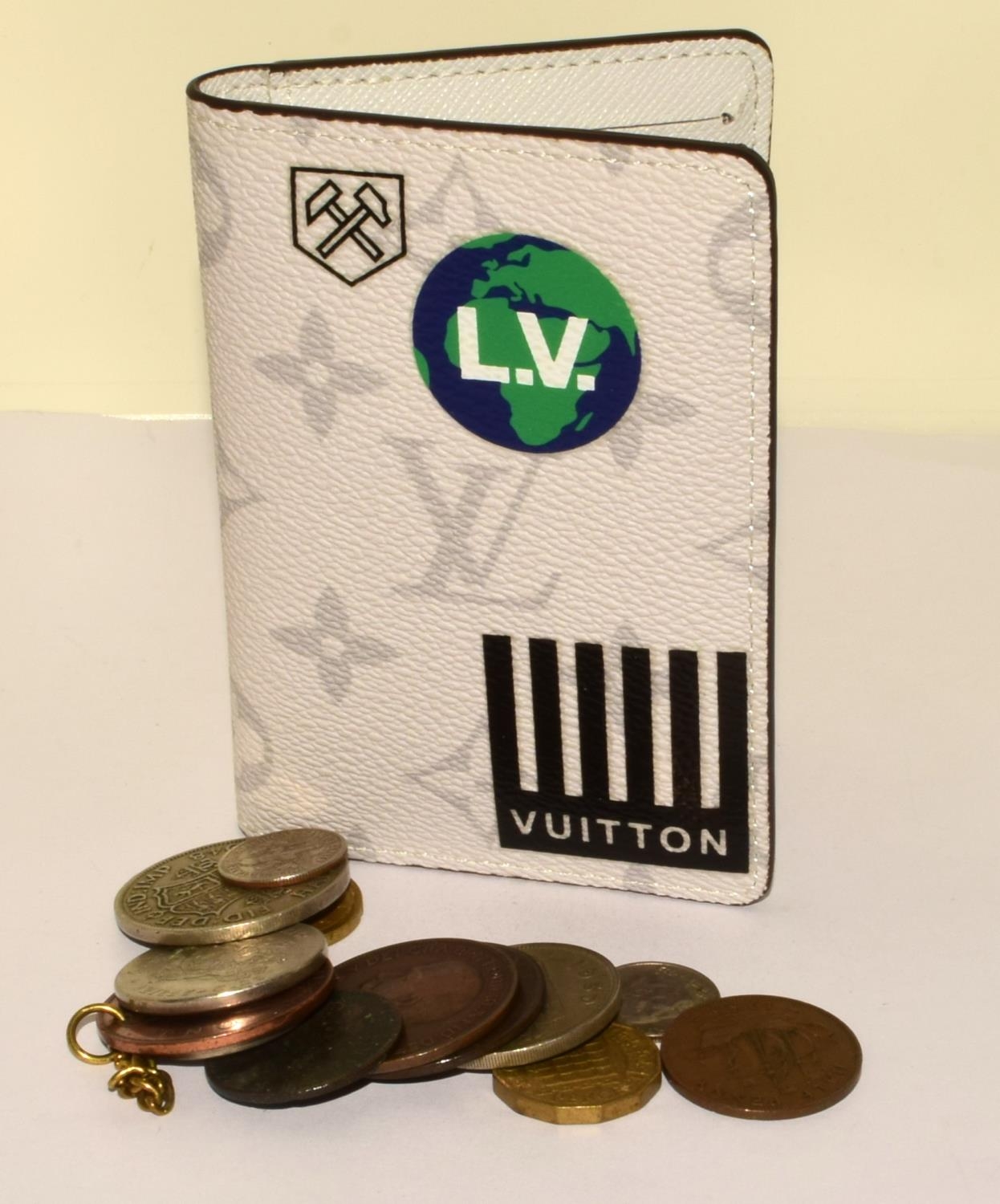 A new unused Wallet marked Vuitton and a quantity of coins ref 22, 23