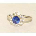 A 925 silver flower ring with blue stone to centre, size O