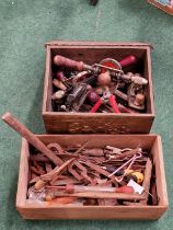Brass box and wooden box both containing a large collection of vintage hand tools.