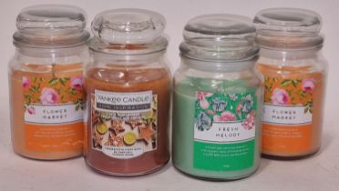 A large Yankee candle t/w 3 large jar candles. (268, 223)