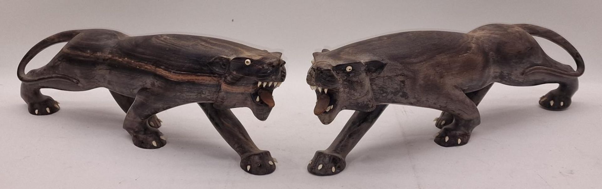 Pair of rare heavy wood carved tigers each 45cm long.