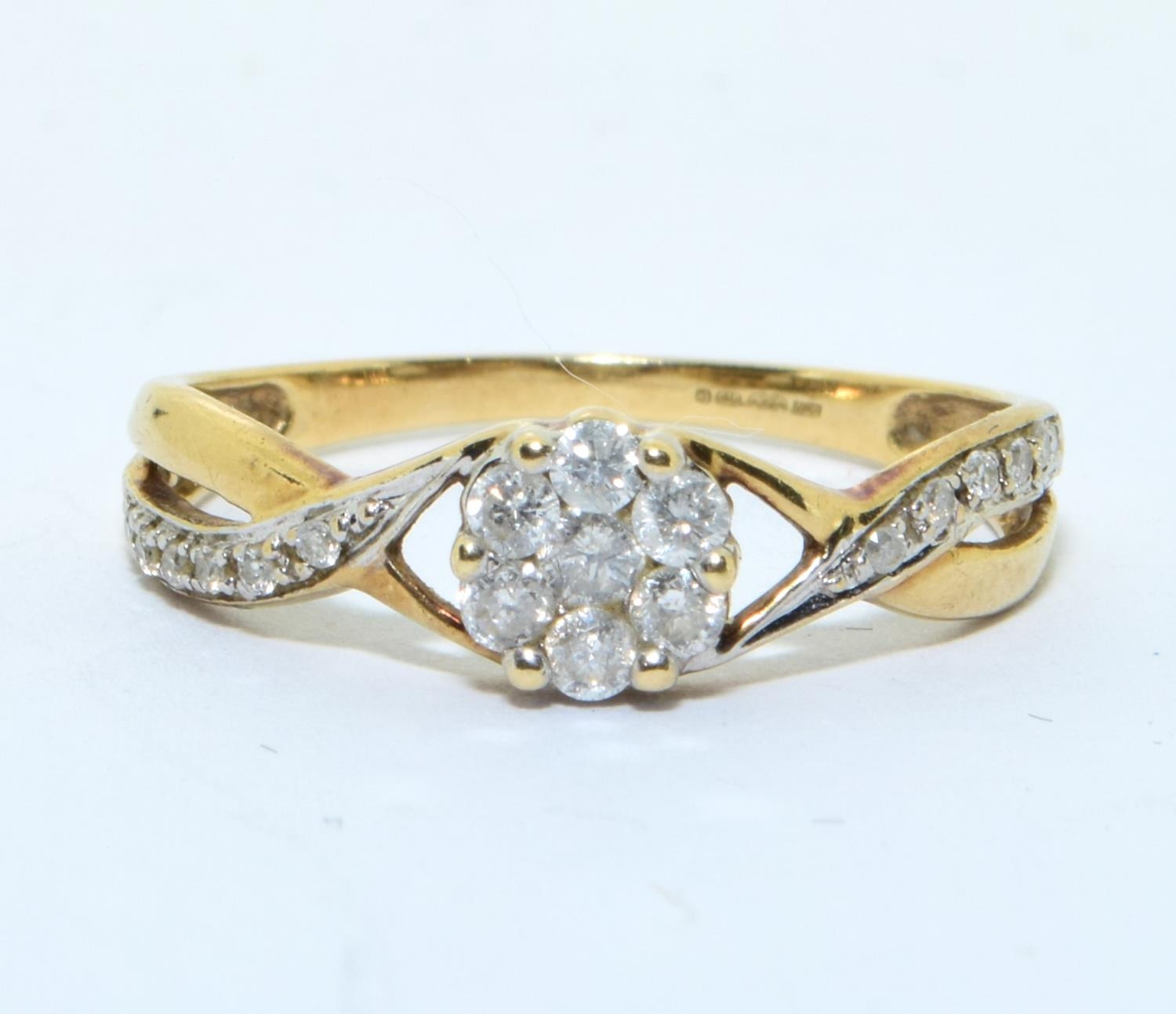 9ct gold Diamond cluster ring with Diamonds to the shank hall marked as 0.25ct size N