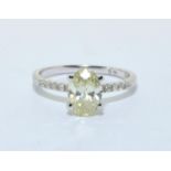 Diamond solitaire approx 1.5ct oval shape yellow diamond with diamond shoulders in a 14ct white gold