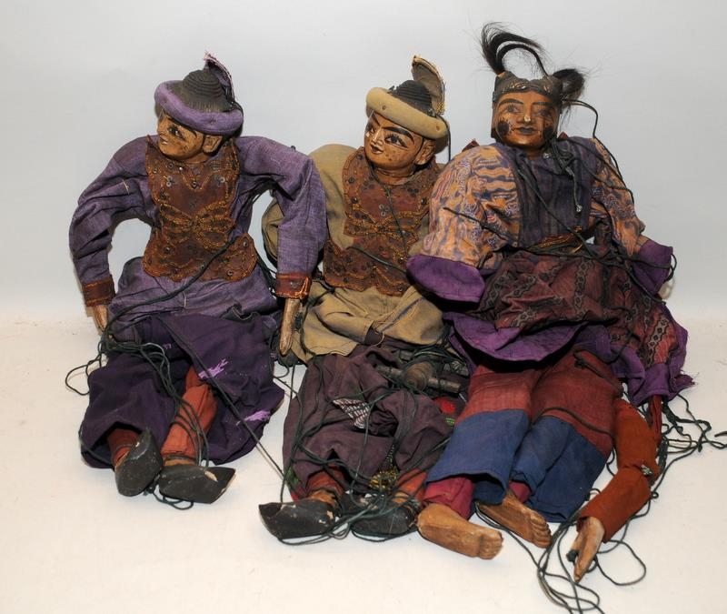 Three vintage Eastern puppets with terracotta heads and limbs wearing traditional dress. Approx