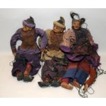 Three vintage Eastern puppets with terracotta heads and limbs wearing traditional dress. Approx