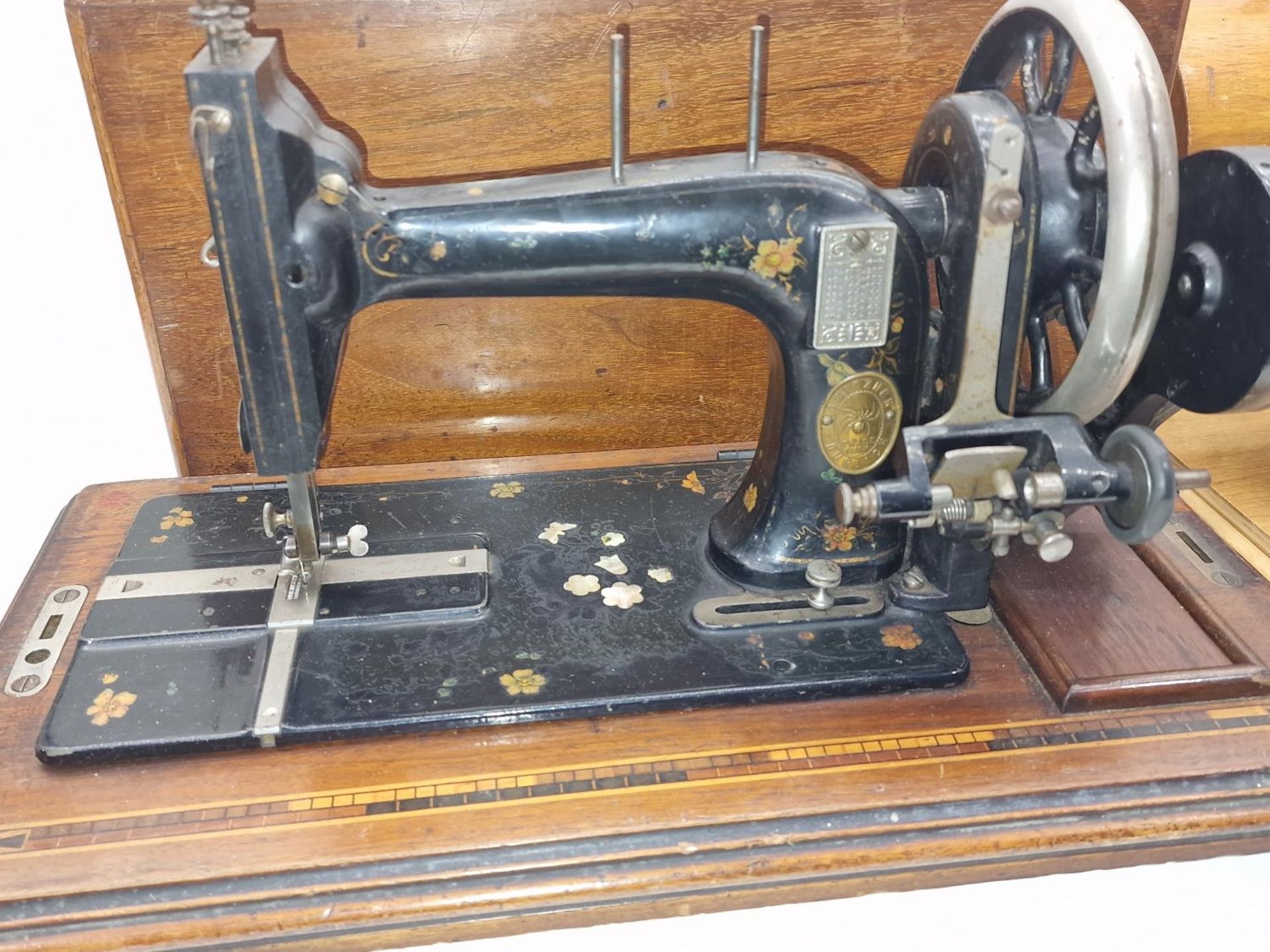 Vintage Grain miniature toy sewing machine together with a larger sewing machine. - Image 3 of 3