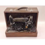 Vintage Singer electric sewing machine cased with acceswsories.