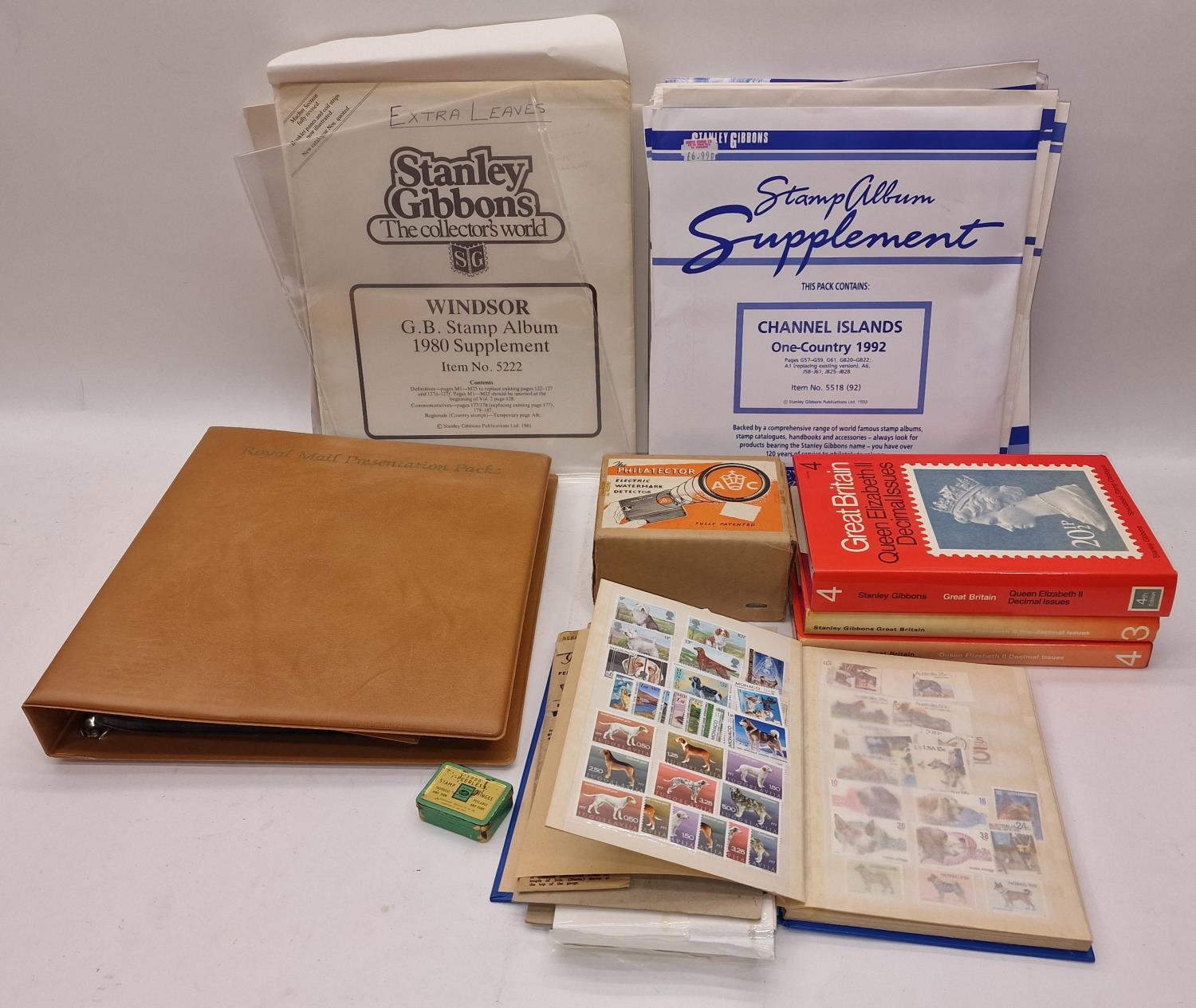 Collection of stamp mounts, supplements, first day covers and some stamps in a stockbook.