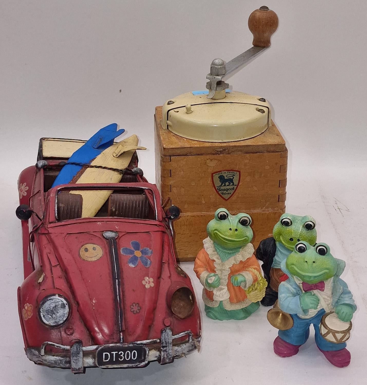 Vintage French Peugeot coffee grinder together with a tin plate model of a car and three frog
